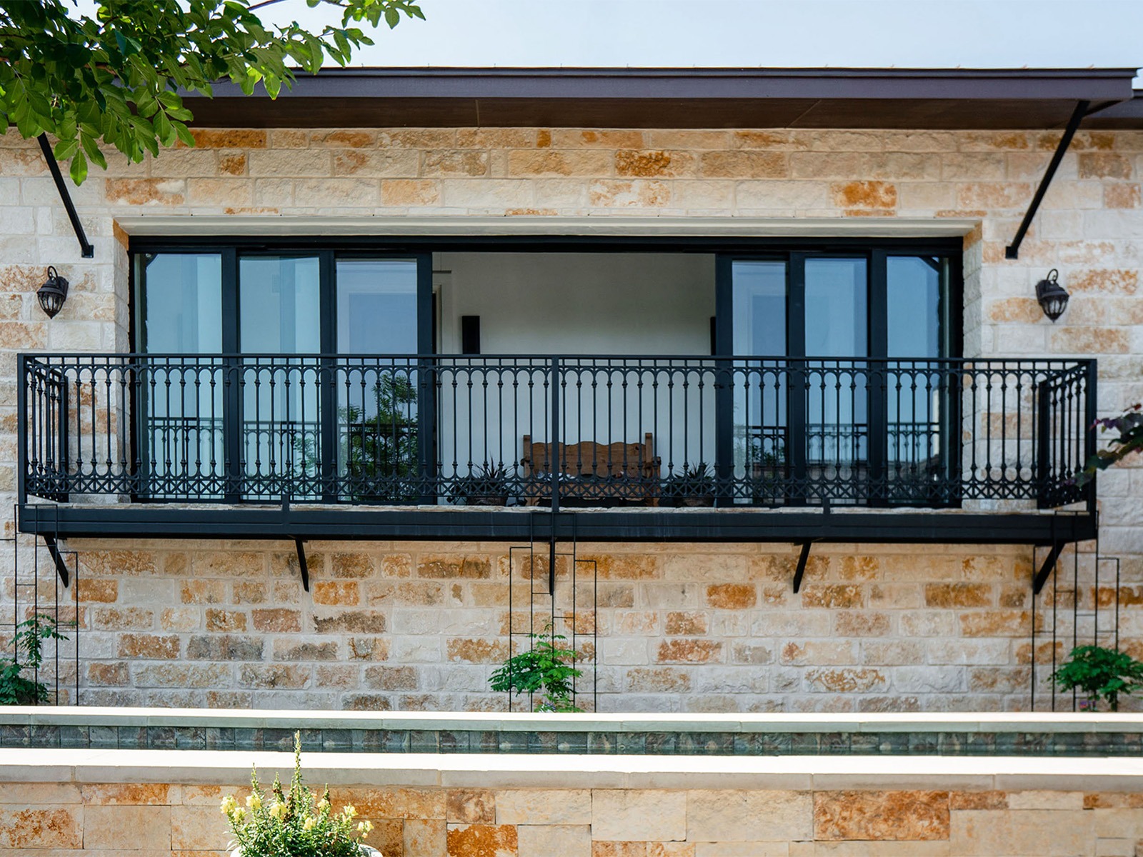 Wrought iron sliding doors on a Texas home by Colonial Iron Doors